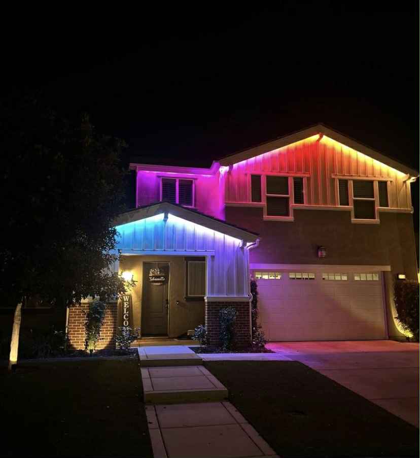Modern home with multicolor roofline and tree lighting